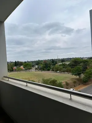 a view of a field from a window at REGENCY APARTMENT HOTEL-ST@Y in Pretoria