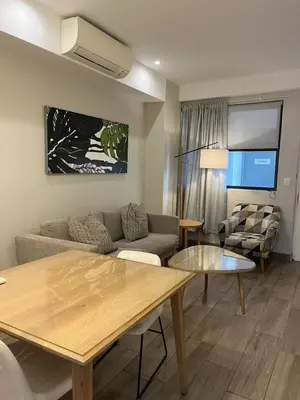 a living room with a couch and a table at REGENCY APARTMENT HOTEL-ST@Y in Pretoria