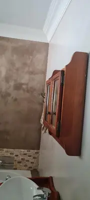 a bathroom with a sink and a mirror at Streetview Suites in Polokwane