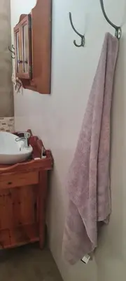 a bathroom with a sink and a towel at Streetview Suites in Polokwane