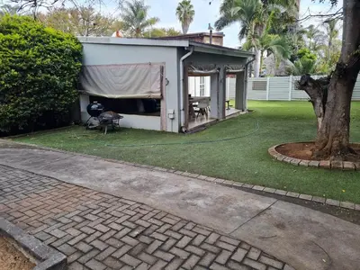 a gazebo with a tent in a yard at Streetview Suites in Polokwane