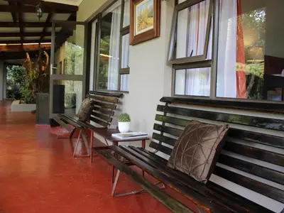 two benches sitting in a room with windows at Ambience Inn in White River