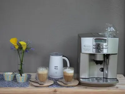 a coffee maker and two glasses of coffee on a table at Ambience Inn in White River