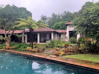 a house with a swimming pool in front of it at Ambience Inn in White River