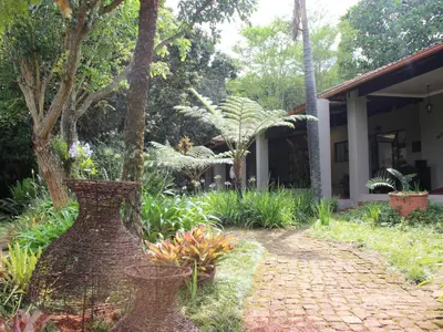 a garden with a brick walkway in front of a building at Ambience Inn in White River