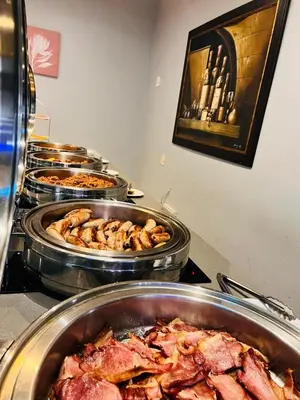 a buffet with many different types of food in pans at Khayalami Hotel - Ermelo in Ermelo
