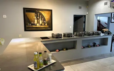 a room with a counter with bottles on a table at Khayalami Hotel - Ermelo in Ermelo