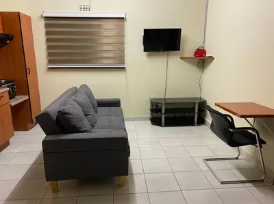 a living room with a couch and a table at The Royal Nest in Sandown