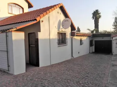 a white building with a gate and a driveway at The Royal Nest in Sandown