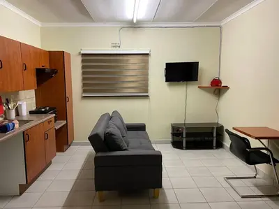 a living room with a couch and a table at The Royal Nest in Sandown