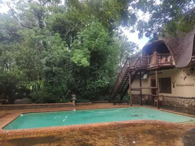 a house with a swimming pool with a deck at Lapalosa Lodge in Centurion