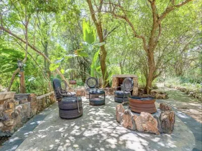 a group of chairs and trees in a yard at Lapalosa Lodge in Centurion