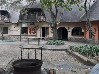 a building with a table in front of it at Lapalosa Lodge in Centurion