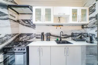 a kitchen with white cabinets and a sink at Homes of Ace Diamond in Pretoria
