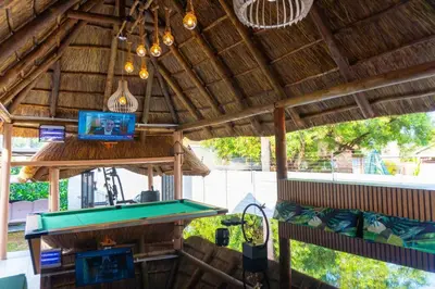a ping pong table in a pavilion with a pool at Homes of Ace Diamond in Pretoria