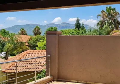 a balcony with a view of the mountains at 10 Pecanwood Dr 4 Bedroom Beauty in Hartbeespoort