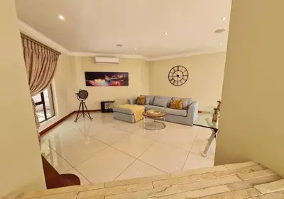 a living room with a couch and a table at 10 Pecanwood Dr 4 Bedroom Beauty in Hartbeespoort