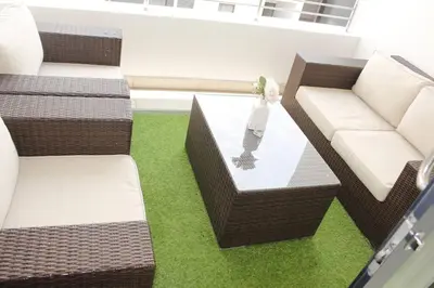 a room with couches and a vase on a table at Chic Home in Erand