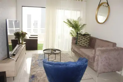 a living room with a couch and a table at Chic Home in Erand
