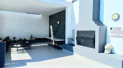 a living room with a table and a fireplace at Chic Home in Erand