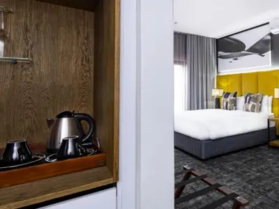 a hotel room with a bed and a tea kettle at Panorama Villa in Graskop