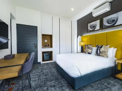 a hotel room with a bed and a desk at Panorama Villa in Graskop