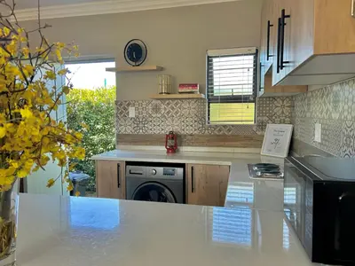 a kitchen with a stove and a dishwasher at The Acorn @ Skyfall Country Estate in Polokwane