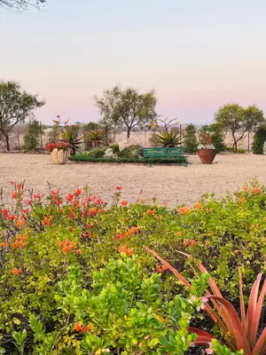 a park with a green bench and some flowers at The Acorn @ Skyfall Country Estate in Polokwane