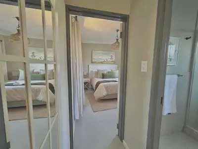 a view of a bedroom with a bed and a mirror at The Acorn @ Skyfall Country Estate in Polokwane