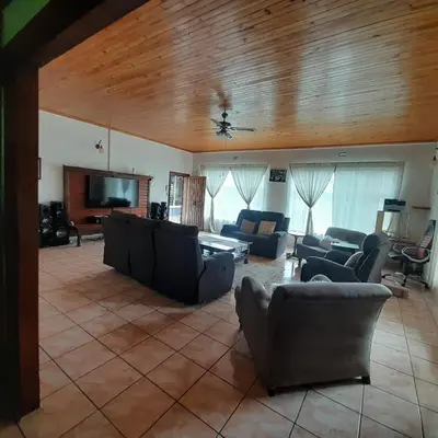 a living room with couches and a flat screen tv at 38 On Andrew Street in Sabie