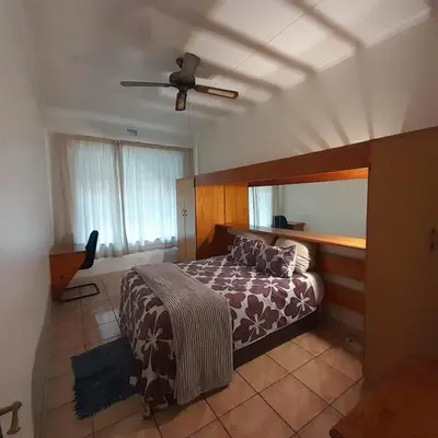 a bedroom with a bed and a ceiling fan at 38 On Andrew Street in Sabie