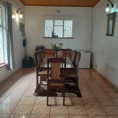 a dining room with a table and chairs at 38 On Andrew Street in Sabie