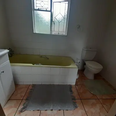 a bathroom with a green tub and a toilet at 38 On Andrew Street in Sabie