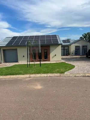 a house with solar panels on top of it at De Marea villa in Naboomspruit