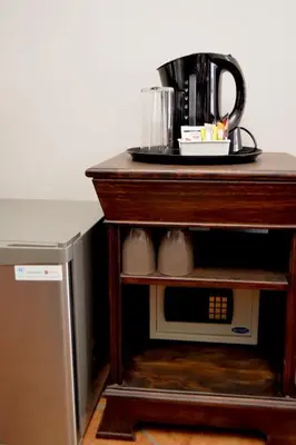 a table with a plate on top of a microwave at Barnstormers Rest in Malelane
