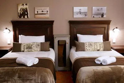 two beds in a hotel room with towels on them at Barnstormers Rest in Malelane