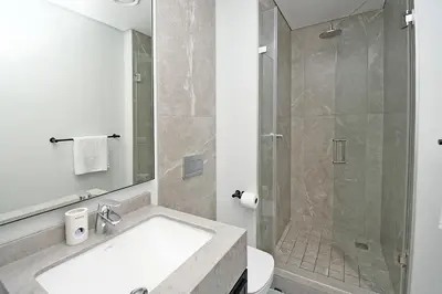 a bathroom with a shower and a sink and a toilet at Thango Res in Johannesburg