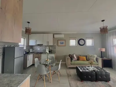 a kitchen and living room with a couch and a table at The Cozy Nook @ Skyfall Country Estate in Polokwane