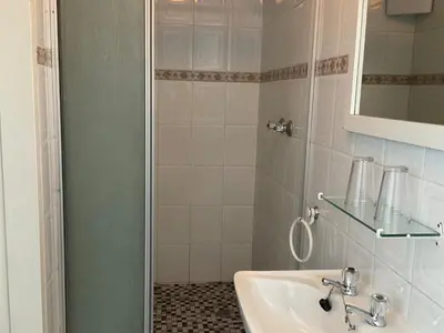 a bathroom with a sink and a shower at Jopasso Guest House in Pretoria