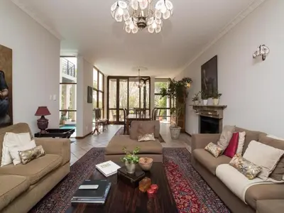 a living room with two couches and a fireplace at Jopasso Guest House in Pretoria