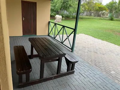 a wooden bench sitting on the porch of a house at Pendleberry Grove Unit 51 in Bela-Bela