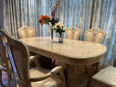 a dining room table with a vase of flowers on it at 337 Justice Mahomed Guest House in Pretoria