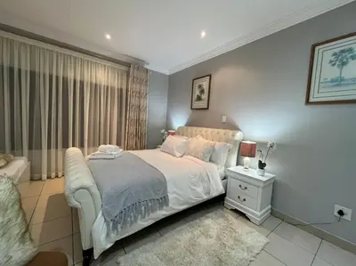 a bedroom with a white bed and a window at 337 Justice Mahomed Guest House in Pretoria
