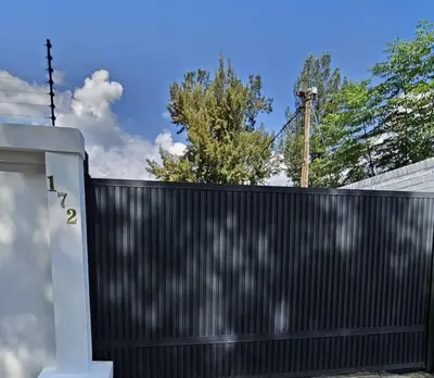 a black fence in front of a house at DBright Lodge in Pretoria