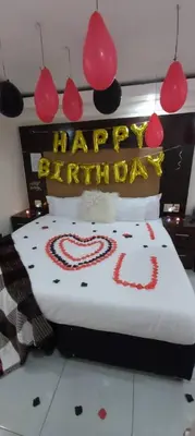 a bed with a happy birthday sign on top of it at DBright Lodge in Pretoria