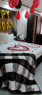 a bedroom with a bed with a blanket and a mirror at DBright Lodge in Pretoria