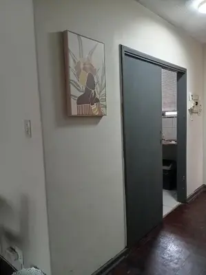 a hallway with a door and a picture on the wall at Comfy spacious apartment in Pretoria