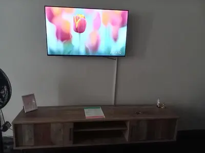 a flat screen tv hanging on a wall at Comfy spacious apartment in Pretoria