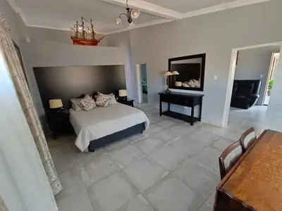 a bedroom with a bed and a table and a piano at Clyde's on Dale Guest House in Springs