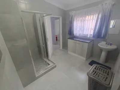 a bathroom with a shower and a sink at Clyde's on Dale Guest House in Springs